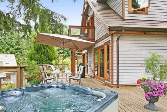 Large furnished deck features a private 5 person hot tub